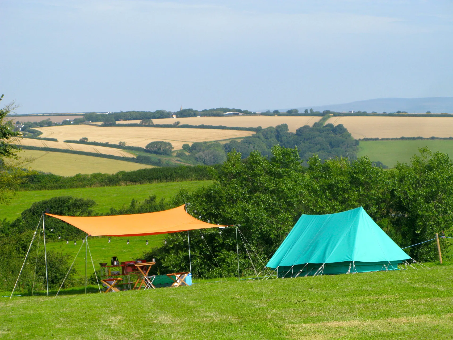 Shade awning and bell tent overlooking the South Devon countryside